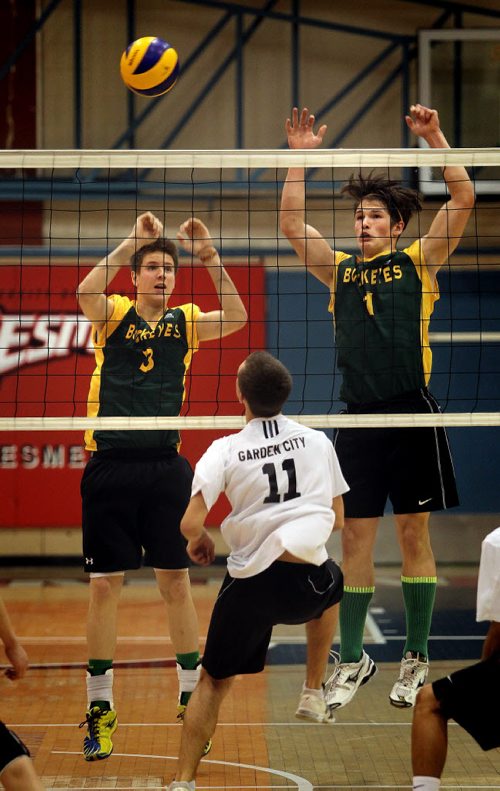 Miles MacDonell Buckeyes #3  Garret Graham and #1 let a spike by Garden City Fighting Go[her #11 Cole Penner slip through their block Monday evening at U of W during the MHSAA "AAAA" Volleyball Championship games.  November 24, 2014 - (Phil Hossack / Winnipeg Free Press)
