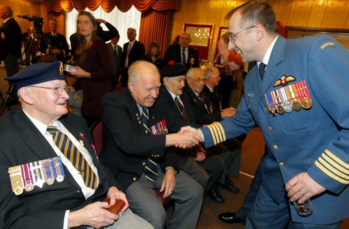LOCAL/STANDUP - Lt.-Gov. Philip S. Lee hosted a reception at Government House to recognize those Manitoba veterans who are to receive the Knight of the National Order of the Legion of Honour from the Government of France for their part in the liberation of France during the Second World War. left- Colonel Joël Roy, wing commander 17 Wing shakes the hands of some vets at the event. BORIS MINKEVICH / WINNIPEG FREE PRESS November 25, 2014