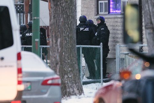 November 25, 2014 - 141125  -  Winnipeg police emergency response unit wait to enter a home during a standoff on Toronto Street Tuesday, November 25, 2014. Police were called to a home on the block between Sargent and Ellice Tuesday afternoon. John Woods / Winnipeg Free Press