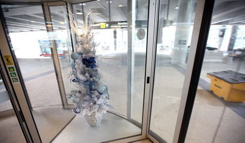 Airport Scenes, various shots to go with Bart Kives story. Seasonal decorations in the revolving doors.....November 25, 2014 - (Phil Hossack / Winnipeg Free Press)