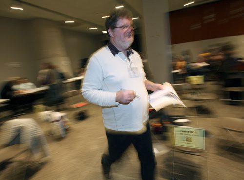 Doug Spiers scrambles trying to solve the day to day problems of the poor Tuesday evening at the United Way "Poverty Challenge". November 25, 2014 - (Phil Hossack / Winnipeg Free Press)