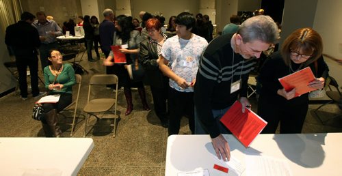 Participants que up trying to solve the day to day problems of the poor Tuesday evening at the United Way "Poverty Challenge". November 25, 2014 - (Phil Hossack / Winnipeg Free Press)