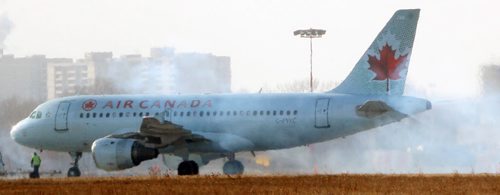 A Air Canada jet fires up its engines in the cold at James A Richardson International Airport in Winnipeg  Wednesday afternoon- See Barts 49.8  Nov 26, 2014   (JOE BRYKSA / WINNIPEG FREE PRESS)