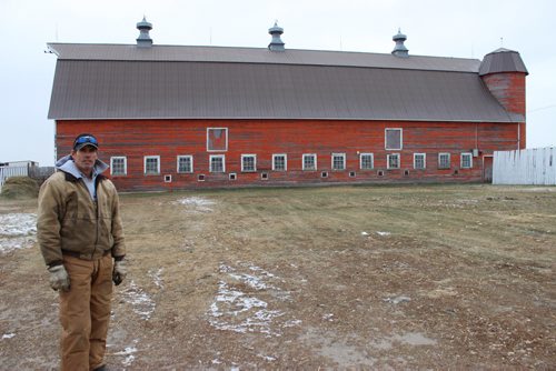 Curtis Gervin and his 9,000-square-foot barn (including loft), built in 1924, near Broomhill. It's believed to be the only double-siloed wood barn still standing in Western Canada. BILL REDEKOP/WINNIPEG FREE PRESS Nov 26, 2014
