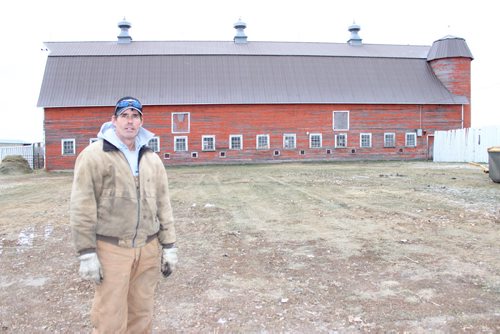 Curtis Gervin and his 9,000-square-foot barn (including loft), built in 1924, near Broomhill. It's believed to be the only double-siloed wood barn still standing in Western Canada. BILL REDEKOP/WINNIPEG FREE PRESS Nov 26, 2014