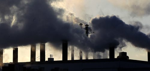 STANDUP - COLD WEATHER - Smoke billows from the stacks at Maple Leaf on the corner of Lagimodiere and Marion. This plants smokes meat and is smelled by hundreds of thousands of drivers every month. BORIS MINKEVICH / WINNIPEG FREE PRESS November 26, 2014