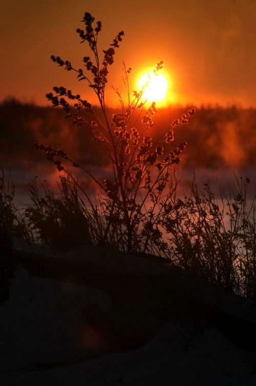 The setting suns orange hue turns the fog rising over the Winnipeg River in Pine Falls  into a fiery looking mist as temperatures dip into the minus 20's Wednesday evening.  Standup photo Nov 26,  2014 Ruth Bonneville / Winnipeg Free Press