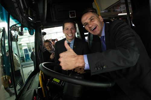 Winnipeg Mayor Brian Bowman and NDP Minister of Jobs and Infrastructure, Kevin Chief (right) are all smiles after the announcement that battery electric transit buses are going to be deployed at the James Armstrong Richardson Airport for a Winnipeg Transit route. It recharges it's battery in about ten minutes, enough to get it through its two-hour route.  141127 - Thursday, November 27, 2014 -  (MIKE DEAL / WINNIPEG FREE PRESS)