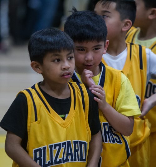 Caden Tugade and Andrei Mallari (right) watch as the players enter the gym. Almost 1,000 players gathered Sunday to take part in the opening ceremonies for the Philippine Basketball Association Winnipeg Basketball League.  141123 - Tuesday, November 25, 2014 -  (MIKE DEAL / WINNIPEG FREE PRESS)