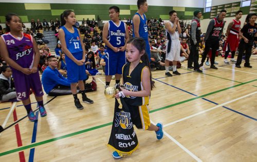 Cherysse Ragot, 8, walks back to her team after accepting the award for best team uniform for her age group as almost 1,000 players gathered Sunday to take part in the opening ceremonies for the Philippine Basketball Association Winnipeg Basketball League.  141123 - Tuesday, November 25, 2014 -  (MIKE DEAL / WINNIPEG FREE PRESS)