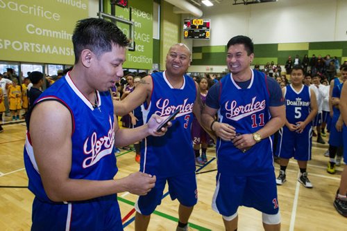 Mario Olaes (left) is teased by teammates Jason Olaes (centre) and Ryan Capina (right) after Mario read an oath of sportsmanship to the almost 1,000 players gathered Sunday to take part in the opening ceremonies for the Philippine Basketball Association Winnipeg Basketball League.  141123 - Tuesday, November 25, 2014 -  (MIKE DEAL / WINNIPEG FREE PRESS)