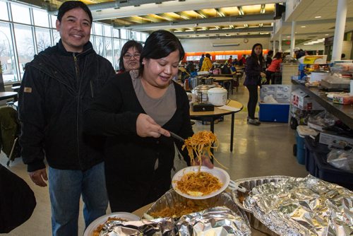 Liz Leung serves up a traditional dish of Palabok during the all-day event at Garden City Collegiate. Almost 1,000 players gathered Sunday to take part in the opening ceremonies for the Philippine Basketball Association Winnipeg Basketball League.  141123 - Tuesday, November 25, 2014 -  (MIKE DEAL / WINNIPEG FREE PRESS)