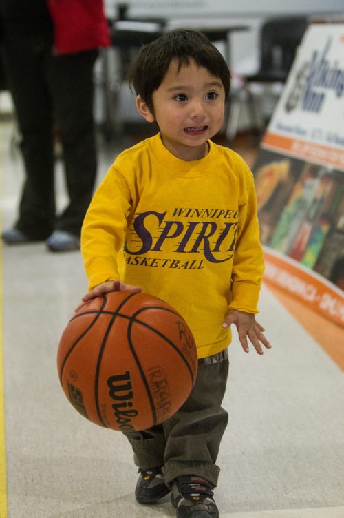 Christopher Castres, 2, plays around with an extra ball while his older brother is plays a game. Almost 1,000 players gathered Sunday to take part in the opening ceremonies for the Philippine Basketball Association Winnipeg Basketball League.  141123 - Tuesday, November 25, 2014 -  (MIKE DEAL / WINNIPEG FREE PRESS)