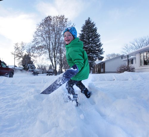 Five-year-old Levy Pylypiv looks back at his mom as he races down the sidewalk to with his shovel to help her clear the snow Saturday Morning in south St. Vital. Standup photo. Nov 29,  2014 Ruth Bonneville / Winnipeg Free Press