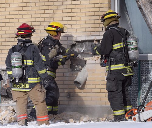 STDUP LOCAL . Wpg Firefighters break a hole in the exterior wall of Garden City Collegiate looking for signs of a fire started inside the school .  Dec. 1 2014 /KEN GIGLIOTTI / WINNIPEG FREE PRESS