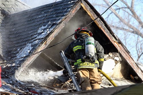 Winnipeg Fire crews on the scene of a house fire on Magnus Avenue Tuesday around the noon-hour.  141202 December 02, 2014 Mike Deal / Winnipeg Free Press