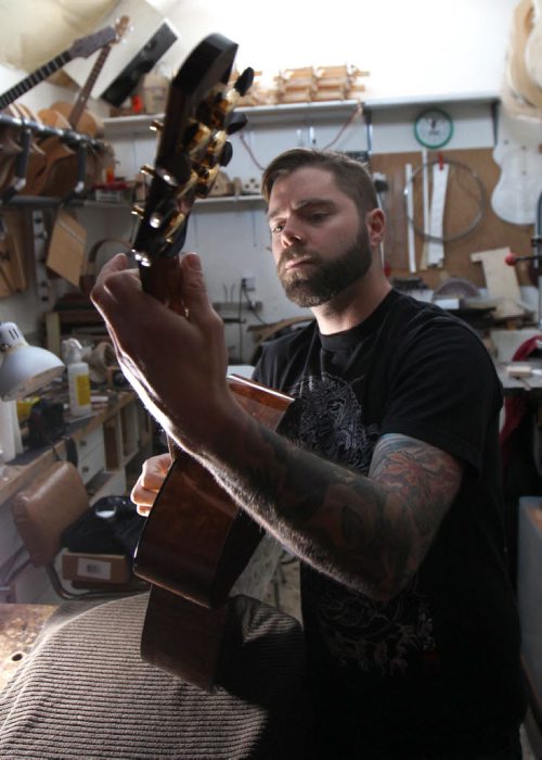 Jordon McConnells tries out one of his custom made acoustic guitars - For photo page Arts feature  Dec 02, 2014   (JOE BRYKSA / WINNIPEG FREE PRESS)