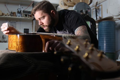 Jordon McConnell guitar maker in Winnipeg in his studio does some finishing touches on one of his custom made acoustic guitars - For photo page Arts feature  Dec 02, 2014   (JOE BRYKSA / WINNIPEG FREE PRESS)