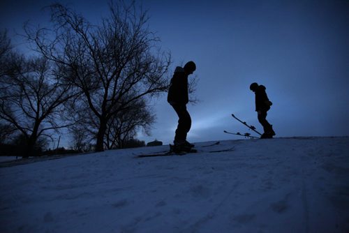 High school students Will Purves (left)  and  Rheis Penner (right, helmet), take advantage of the warmer weather and remaining later afternoon light to ski down the hill at Omands Creek Tuesday afternoon. Standup photo.   Dec 02,  2014 Ruth Bonneville / Winnipeg Free Press