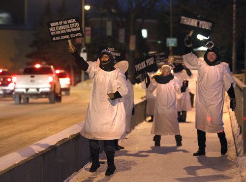 At left, Joann White with the Angel Squad were out dancing on the Maryland Bridge Wednesday morning waving at passing motorists and encouraging them to stop and make a donation for Misericordia Health Centre.  The Squad will be out again on Thursday from 7 - 9 a.m. Wayne Glowacki / Winnipeg Free Press Dec.3  2014