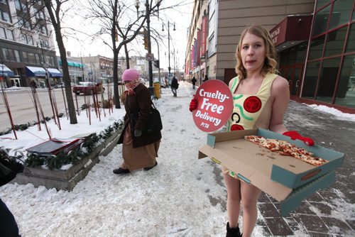 Courtney Shwetz promotes the virtues of being vegan as she hands out free vegan pizza wearing only short dress in front of Portage Place Wednesday.   See Bartley Kives story.  Dec 03,  2014 Ruth Bonneville / Winnipeg Free Press