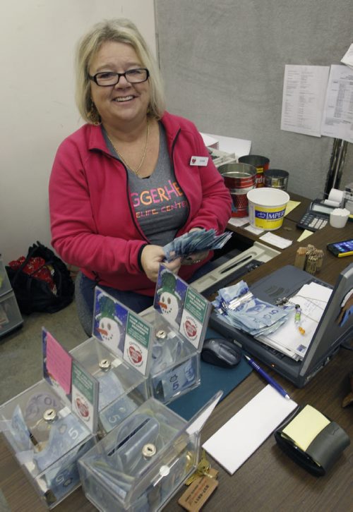 Volunteers. Susan Gill, has volunteered with the Christmas Cheer Board for the past 10 years. Here she is counting money from donation boxes. Story by Aaron Epp  Wayne Glowacki / Winnipeg Free Press Dec.3  2014