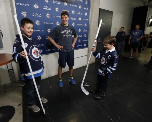 LOCAL - Jets autographed stick . MTS Centre.   LtoR 13-year-old Evan Chartrand (wearing Jets Jersey #31) , the Äúmystery boyÄù  recieves autographed stick from Mark Scheifele as a reward with  Eight-year-old Connor  McDaniel (wearing Jets jersey #16 ) . The Äúmystery boyÄù 13-year-old Evan Chartrand who picked up Jets autographed stick dropped over the glass by Mark Scheifele and gave it to the younger boy it was intended for.  After practice Scheifele met  the boys  (Scheifele  presenting  Evan with a smilar stick  for his graciousness, . FOR Sinclair columnDec. 4 2014 / KEN GIGLIOTTI / WINNIPEG FREE PRESS