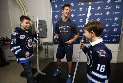 LOCAL - Jets autographed stick . MTS Centre.   LtoR 13-year-old Evan Chartrand (wearing Jets Jersey #31) , the Äúmystery boyÄù  recieves autographed stick from Mark Scheifele as a reward with  Eight-year-old Connor  McDaniel (wearing Jets jersey #16 ) . The Äúmystery boyÄù 13-year-old Evan Chartrand who picked up Jets autographed stick dropped over the glass by Mark Scheifele and gave it to the younger boy it was intended for.  After practice Scheifele met  the boys  (Scheifele  presenting  Evan with a smilar stick  for his graciousness, . FOR Sinclair columnDec. 4 2014 / KEN GIGLIOTTI / WINNIPEG FREE PRESS