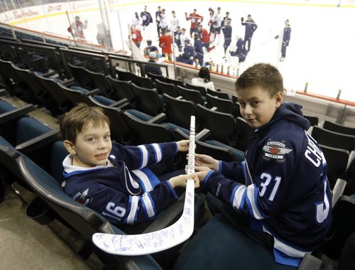 LOCAL - Jets autographed stick . MTS Centre.  Eight-year-old Connor  McDaniel (wearing Jets jersey #16 ) meets 13-year-old Evan Chartrand (wearing Jets Jersey #31) , the Äúmystery boyÄù who picked up Jets autographed stick dropped over the glass by Mark Scheifele and gave it to the younger boy it was intended for. The kids had the pleasure of  watching the Jets practice. After practice photo of Scheifele and the boys (Scheifele will be presenting Evan with a gift for his graciousness, probably his autographed stick. FOR Sinclair columnDec. 4 2014 / KEN GIGLIOTTI / WINNIPEG FREE PRESS