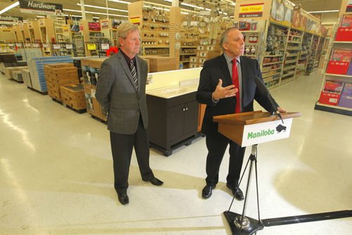 LOCAL - Consumer protection/contractors legislation. Mike Moore, president, Manitoba Home Builders' Association, and Tourism, Culture, Heritage, Sport and Consumer Protection Minister Ron Lemieux make announcement at McMunn and Yates Building Supplies, 600 Pembina Hwy. Improving consumer protection and clarity when dealing with contractors was the topic. NO REPORTER. BORIS MINKEVICH / WINNIPEG FREE PRESS December 4, 2014