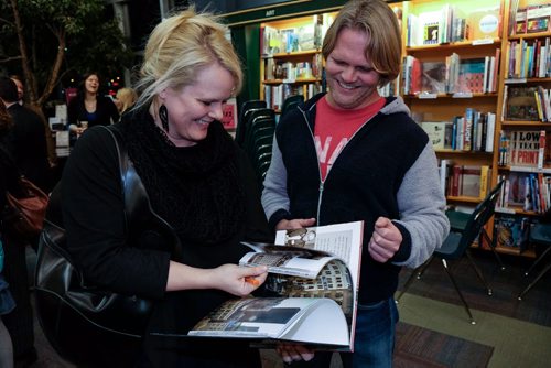 Architect Johanna Hurme (left) and Brent Bellamy (right) look through the book during the launch of the Winnipeg Free Press book City Beautiful at McNally Robinson Thursday evening. 141204 - Thursday, December 04, 2014 -  (MIKE DEAL / WINNIPEG FREE PRESS)
