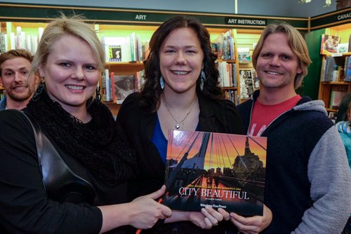Architect Johanna Hurme (left), Photographer and Multimedia Editor Melissa Tait (Centre) and Architect Brent Bellamy (right) look through the book during the launch of the Winnipeg Free Press book City Beautiful at McNally Robinson Thursday evening. 141204 - Thursday, December 04, 2014 -  (MIKE DEAL / WINNIPEG FREE PRESS)