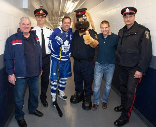 The annual Guns vs. Hoses charity hockey game featuring the Winnipeg Police Patrolmen Hockey Club and the Winnipeg Fire Fighters hockey team took place at the MTS Iceplex on Nov. 21, 2014. Proceeds went toward paramedic Corey Schroeder, who was injured in an explosion in September. Pictured, from left, are Joe Daley (former Winnipeg Jets goalie), Insp. Max Waddell, Gilmour, Copper (Winnipeg Police Service mascot), John Ring and Const. Derrick Siemann. (JOHN JOHNSTON/ WINNIPEG FREE PRESS)