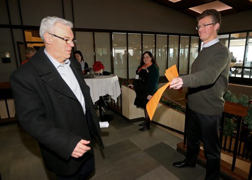 Premier Greg Selinger accepts a statement from the 6 rebel NDP MLAs from Andrew Swan at todays provincial council meeting, Saturday, December 6, 2014. (TREVOR HAGAN/WINNIPEG FREE PRESS)