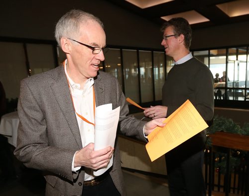 Steve Ashton accepts a statement from the 6 rebel NDP MLAs from Andrew Swan at todays provincial council meeting, Saturday, December 6, 2014. (TREVOR HAGAN/WINNIPEG FREE PRESS)