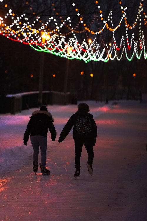 Colorful lights glisten on the skating trail leading over the   old train bridge at the Forks while people enjoy an evening skate in the mild temperatures. Standup photo.  Dec 06,  2014 Ruth Bonneville / Winnipeg Free Press