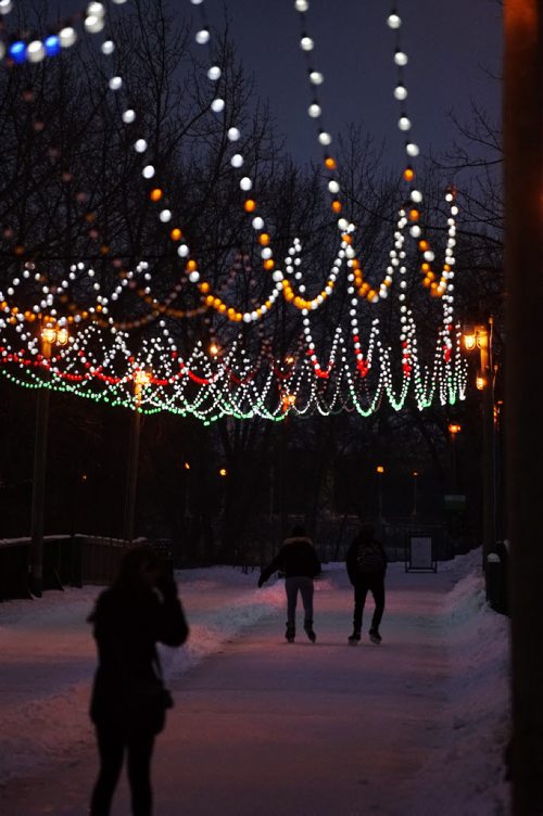 Colorful lights glisten on the skating trail leading over the   old train bridge at the Forks while people enjoy an evening skate in the mild temperatures. Standup photo.  Dec 06,  2014 Ruth Bonneville / Winnipeg Free Press