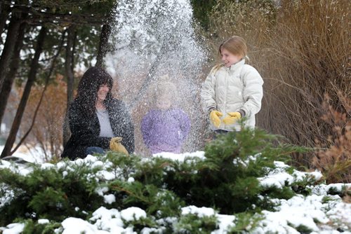 Lori Wiebe and her two daughters Ruby, 3yrs and Rachel 9yrs, enjoy the mild winter temperatures as they play in the snow near the formal garden at Assiniboine Park Saturday afternoon. Standup photo.  Dec 06,  2014 Ruth Bonneville / Winnipeg Free Press
