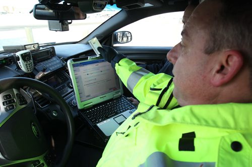 Const Shawn Smith , a  RCMP Headingley officer dhows new technology installed in traffic enforcement police cars that will let officers issue e-Tickets to motorists committing infractions on Manitoba highwaysDuring a traffic stop, an officer will swipe the drivers licensee through a card reader- the offence will be added by the officer  and a e-ticket is generated by the officer. Manitoba RCMP write aprx 34,00 Provincial Offence notices annually-Dec 08, 2014   (JOE BRYKSA / WINNIPEG FREE PRESS)
