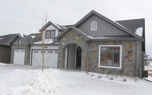 NEW HOMES - 112 Lake Bend Road in Bridgwater Lakes. Hearth Homes Liam Milne rep was there. BORIS MINKEVICH / WINNIPEG FREE PRESS December 8, 2014