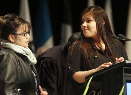 (right) Rinelle Harper being honoured at AFN with an eagle feather  , her mother JUlia Harper  left  sahre a look during the address , her family was around her during the short speech . .Dec. 9 2014 / KEN GIGLIOTTI / WINNIPEG FREE PRESS