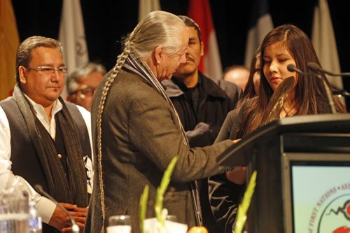 left Chief David Harper .  Chief Regional Chief Bill Traverse gives Rinelle Harper an eagle feather as she was  being honoured at AFN meeting   Dec. 9 2014 / KEN GIGLIOTTI / WINNIPEG FREE PRESS