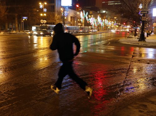 Stdup. Portage Ave ,wet , colourful streets and warm snow melting windshield washer  weather is the order of the day.  Dec. 10 2014 / KEN GIGLIOTTI / WINNIPEG FREE PRESS