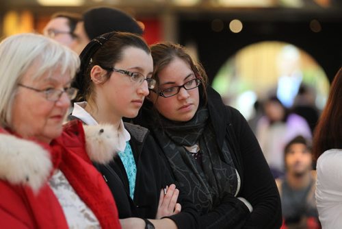 Rachel Kleinsasser and her cousin Krystal Kleinsasser intently watch a multi-media display in the Canadian Journey's exhibit at the CMHR Wednesday afternoon during their free open house in honour of International Human Rights Day.   Dec 10,  2014 Ruth Bonneville / Winnipeg Free Press