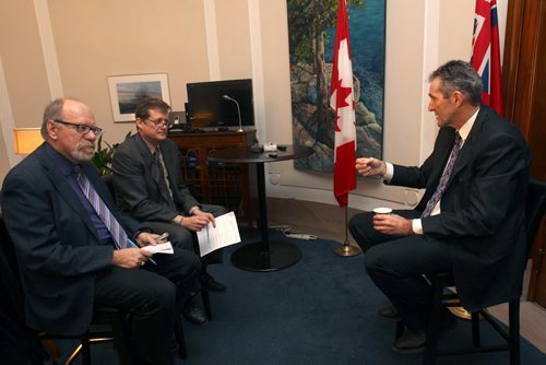 Progressive Conservative Leader Brian Pallister at year end interview at the Manitoba Legislature reads Winnipeg Free Press with FP reporters Larry Kusch and Bruce Owen-  See Bruce Owen Larry Kusch year end interview  Dec 11, 2014   (JOE BRYKSA / WINNIPEG FREE PRESS)