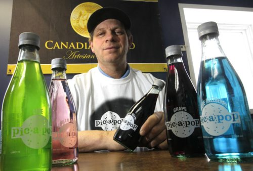 Peter De Jong, pres. of Canadian Gold Beverages Inc. in Marchand Mb. with his Pic-a-pop  selection. Pic-a-pop has been bought and revived by Canadian Gold Beverages. The 1970s pops haven't been available since the Angostura plant shut down five years ago.Geoff Kirbyson story Wayne Glowacki / Winnipeg Free Press Dec.11 2014