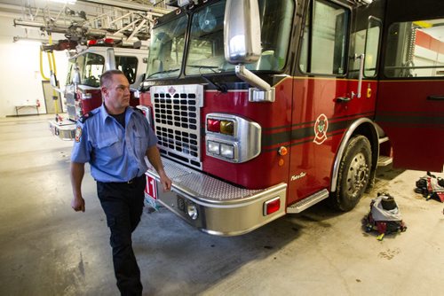 A fire paramedic walks by a truck after returning from a call during a tour of the new Winnipeg Fire Paramedic Service Station 11 at Portage Avenue and Route 90. 141211 - Thursday, December 11, 2014 -  (MIKE DEAL / WINNIPEG FREE PRESS)