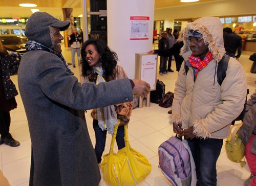 LOCAL - Zeleke Eliso Tuloro greets his family at Winnipeg James Armstrong Richardson International Airport. They are newcomers. Zeleke Eliso Tuloro meeting his family for the first time in 12 years  Teacher Zeleke Eliso Tuloro fled Ethiopia in 2002 as a political opposition party member targeted by military government  his wife and 3 kids stayed. Zeleke arrived in Winnipeg Dec. 12, 2012. In Wpg hes been working as a security guard to raise money to sponsor his family to join him. Here he reacts to his son Nathenael(right), and  oldest daughter Kalkidan(middle). BORIS MINKEVICH / WINNIPEG FREE PRESS December 11, 2014