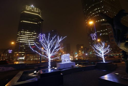Stdup .Bright Lights at Portage Ave. and Main St. but not much evidence of winter with fast melting snow from continuing with an expected Hi of Zero .Dec. 12 2014 / KEN GIGLIOTTI / WINNIPEG FREE PRESS