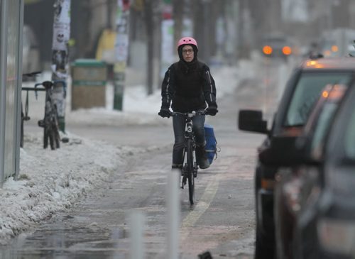 LOCAL - STANDUP - A cyclist speeds down Sherbrook Street in the mild Friday morning temperatures. NO NAME OF CYCLIST. BORIS MINKEVICH / WINNIPEG FREE PRESS December 12, 2014